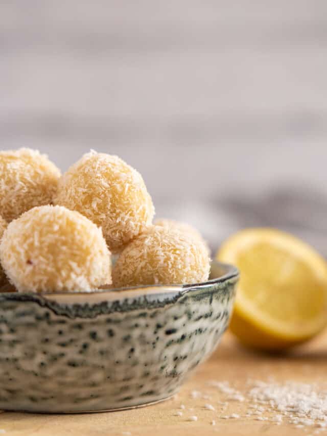 Lemon balls in a bowl on a wooden table.