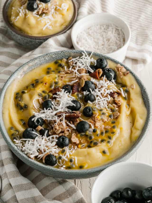 A bowl of food with blueberries and granola.