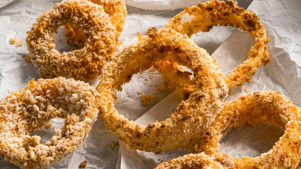 Fried onion rings on a piece of paper.
