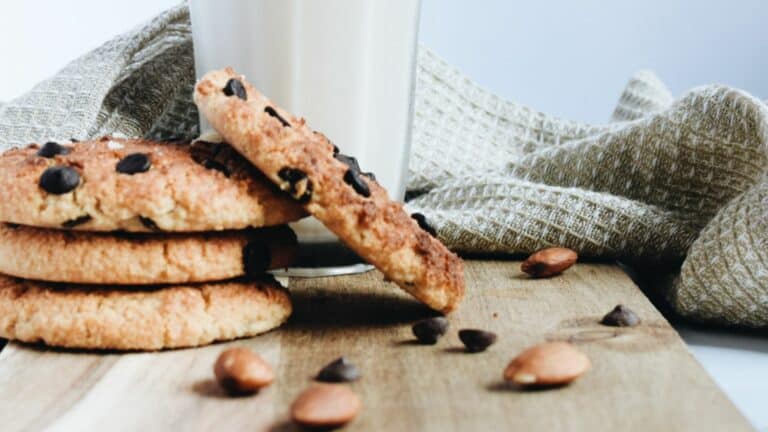 A stack of chocolate chip cookies and a glass of milk.