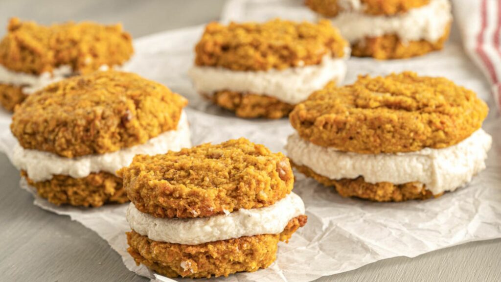 A stack of carrot cake cookies on a piece of paper.
