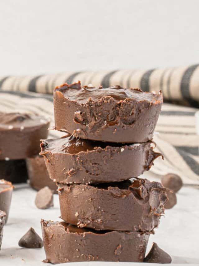 A stack of chocolate fudge cups on a white plate.
