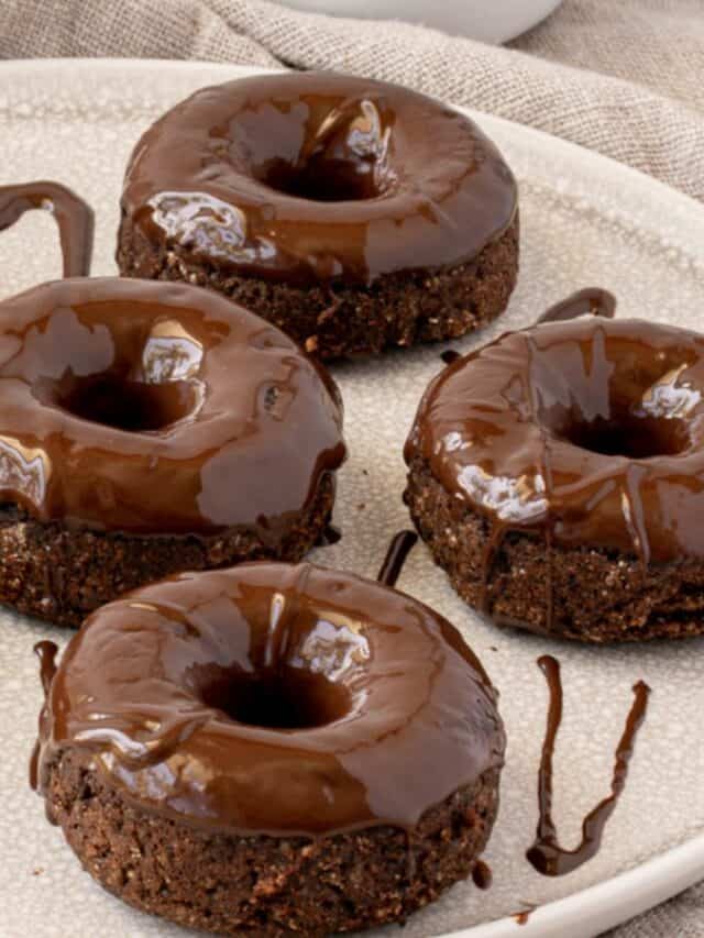 A plate of chocolate-glazed mini cakes with a rich, glossy topping.