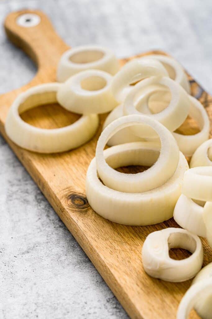 Onion rings on a cutting board.