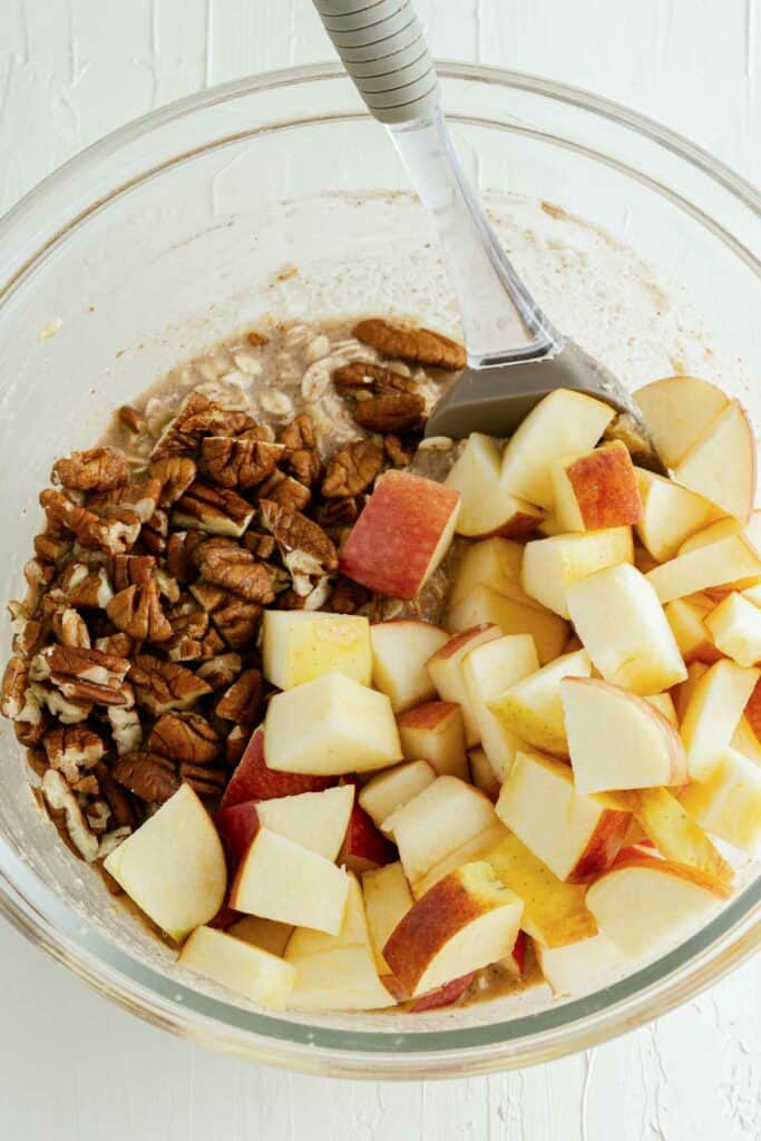 Apples and pecans in a bowl.