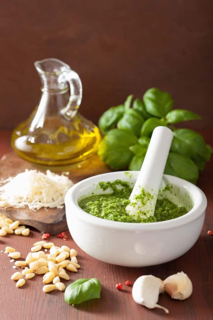 ingredients and pesto sauce over wooden rustic background