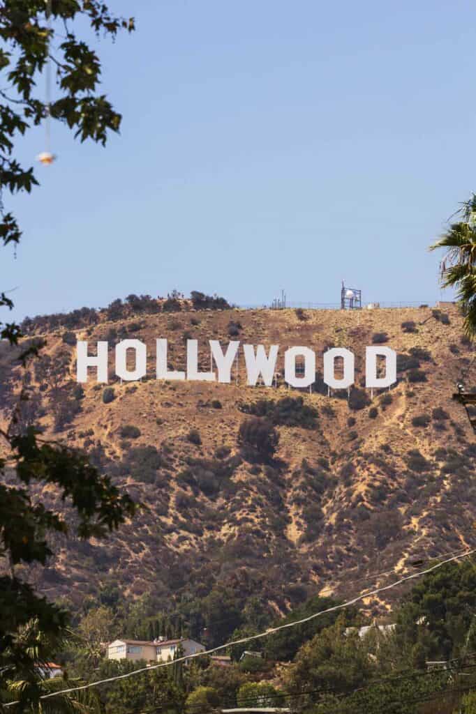 The hollywood sign is on top of a hill.