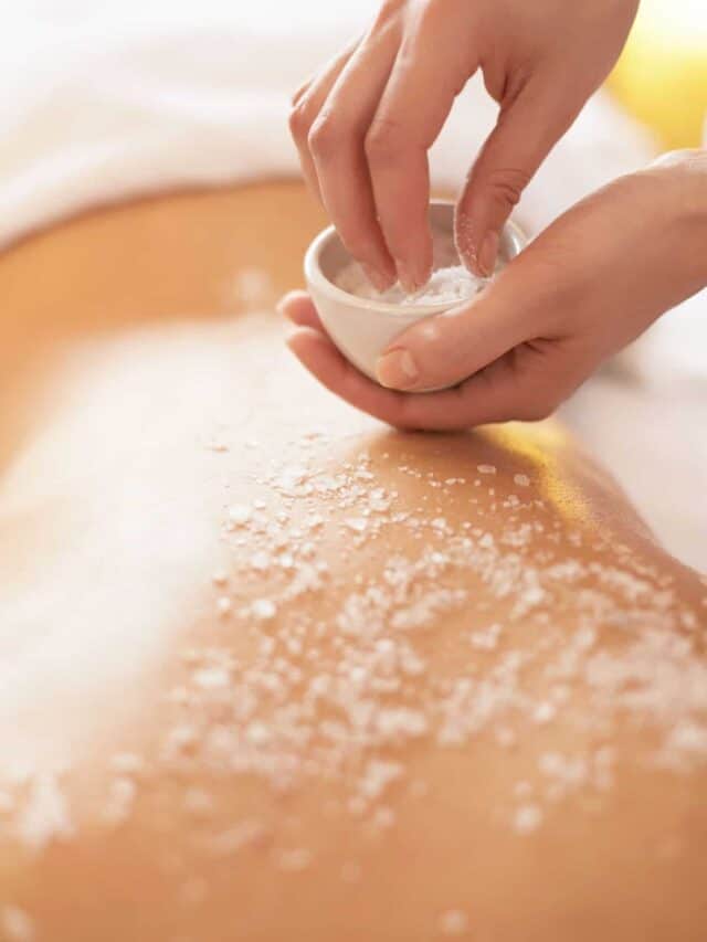 A woman getting a massage with salt on her back.