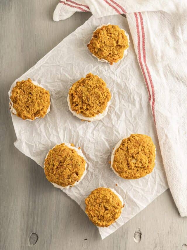 A group of muffins on a white towel.
