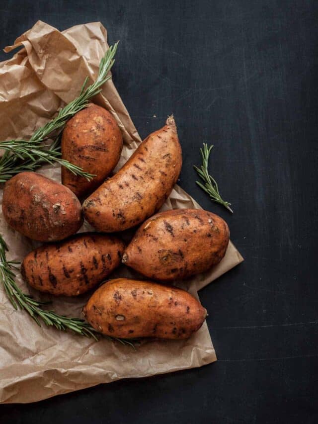 Sweet potatoes in a bag with rosemary sprigs.