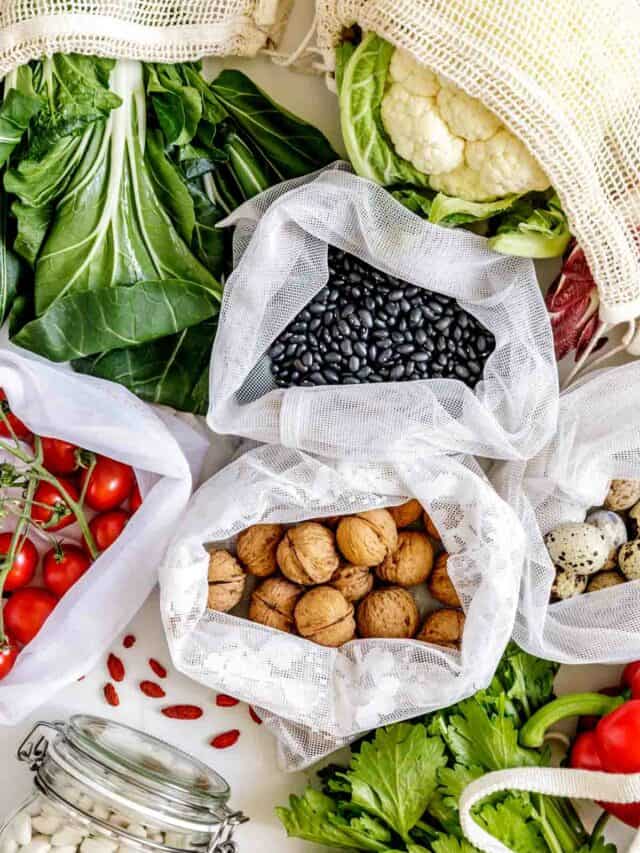 A variety of fruits and vegetables in plastic bags on a white background.