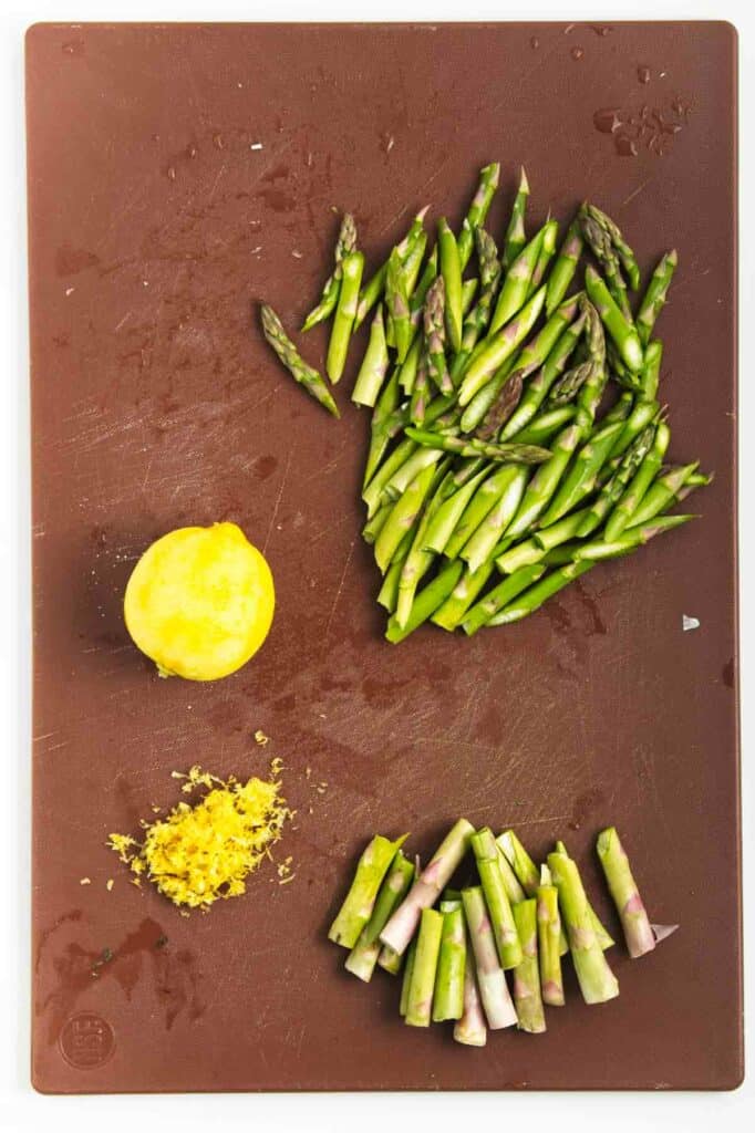 Asparagus Risotto and lemon on a cutting board.