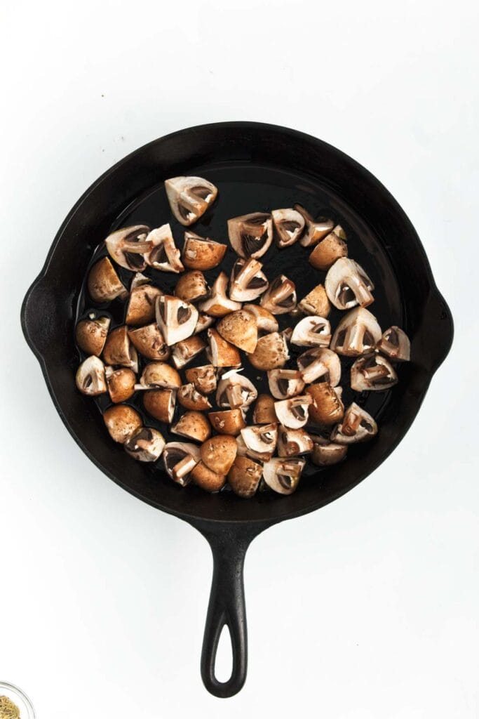 Chopped mushrooms in a skillet.