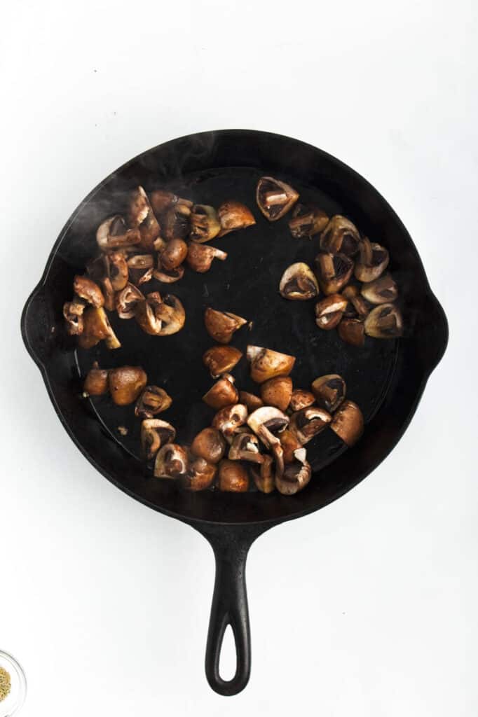 Chopped mushrooms in a skillet.