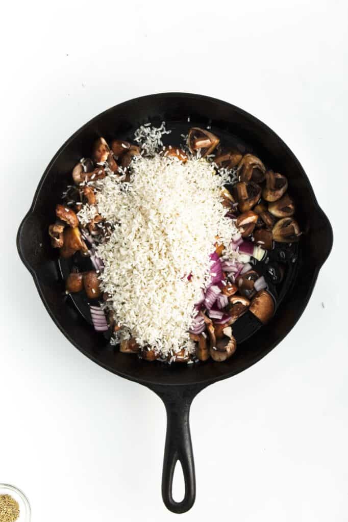 Mushrooms and rice in a skillet.