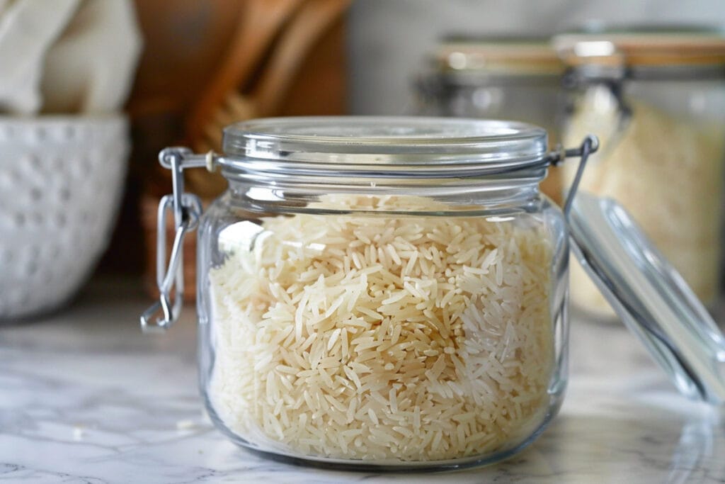 Rice in a glass jar on a counter.