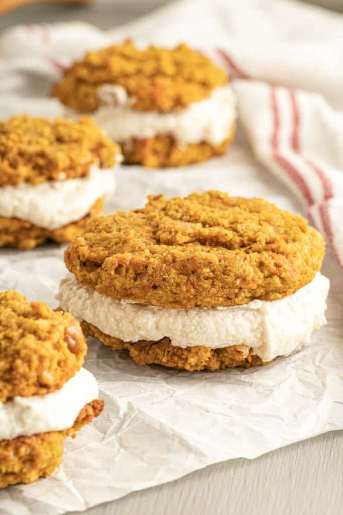 A group of pumpkin cookies on a piece of paper.
