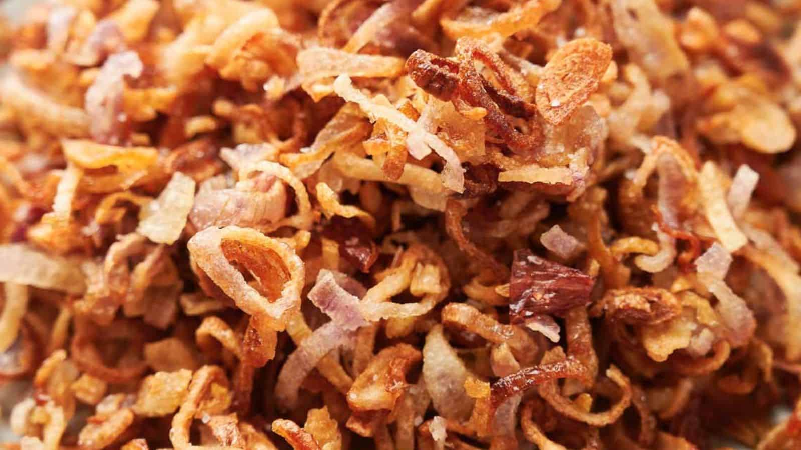 A pile of crispy shallots on a plate.