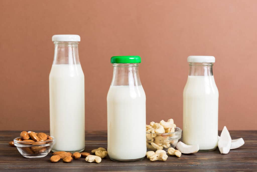 A group of bottles of milk and nuts.