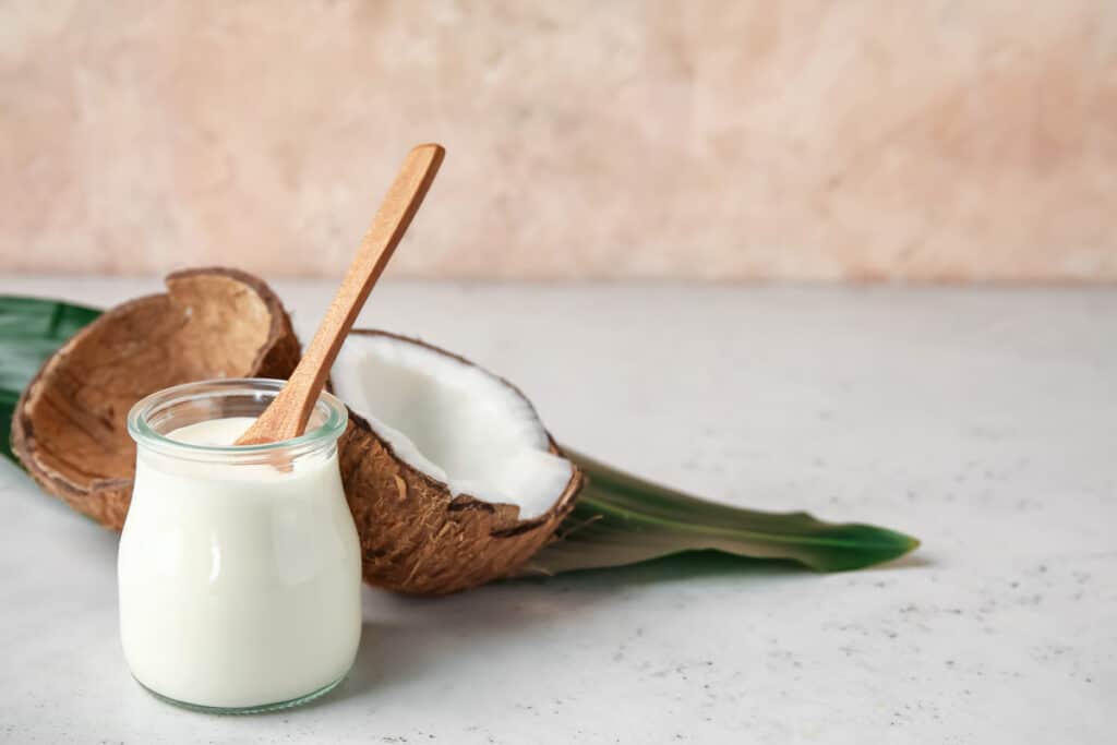 A coconut and milk in a jar.