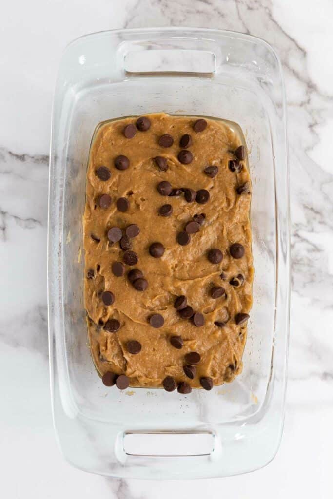Gluten-Free Chocolate chip cookie dough in a glass baking dish.