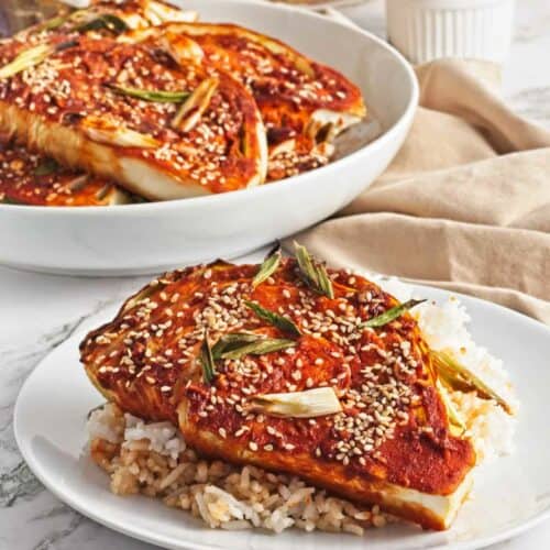 A plate with gochujang cabbage steaks.
