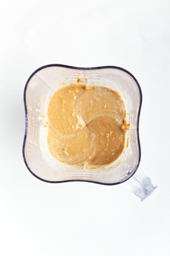 A top-down view of a blender with a creamy, blended mixture inside.