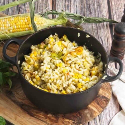 A skillet with sweet corn and leek risotto dish.