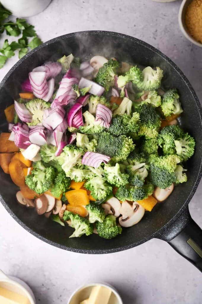 Preparing a vegetable casserole in a pan.