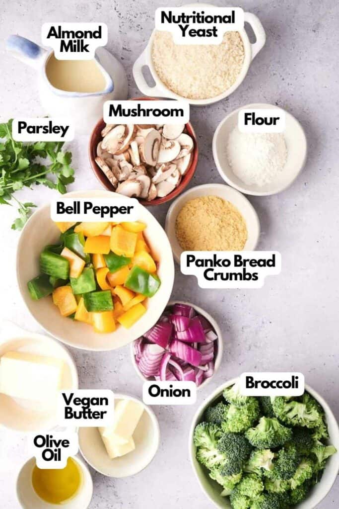 A list of ingredients for a vegan Vegetable Casserole recipe labeled and neatly arranged on a white surface.