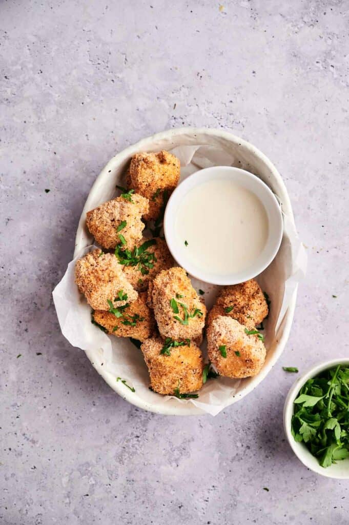 Vegan chicken nuggets in a bowl with dip.