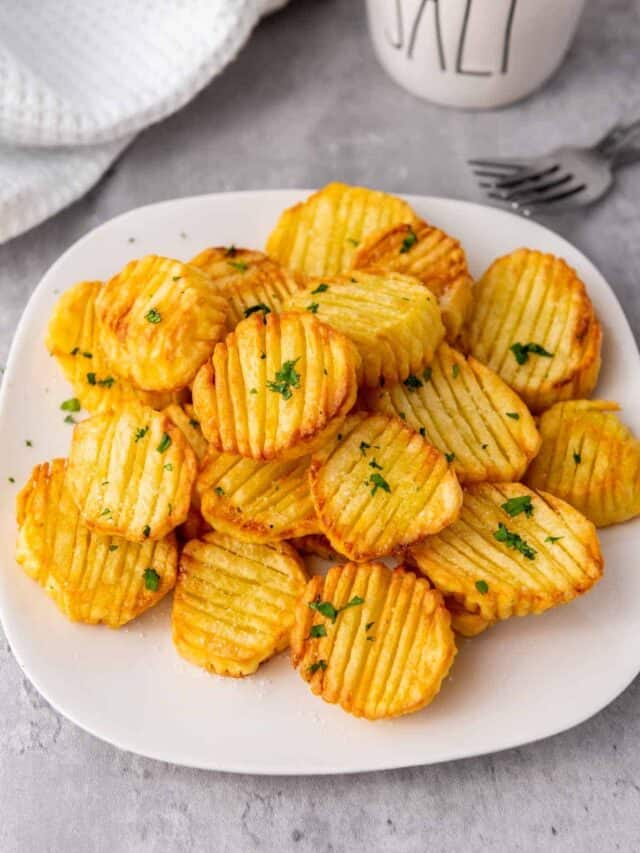 Potato wedges on a plate with a cup of coffee.