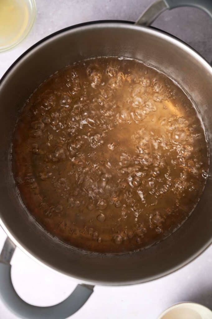 A top view of a pot with boiling liquid.