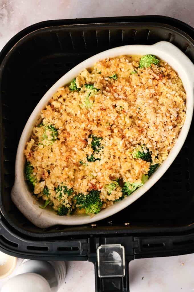Oval dish filled with a delightful air fryer vegan broccoli and rice casserole, topped with a golden breadcrumb crust.