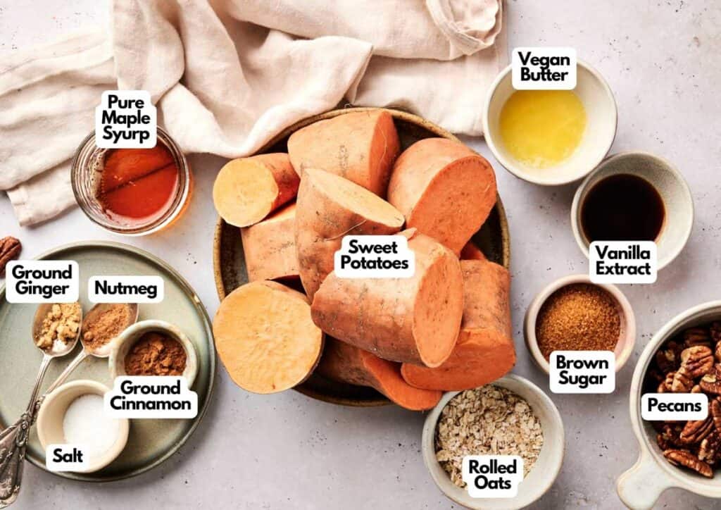Bowls of labeled ingredients for Air Fryer Sweet Potato Casserole, including sweet potatoes, spices, oats, pecans, maple syrup, vegan butter, vanilla extract, brown sugar, and salt.